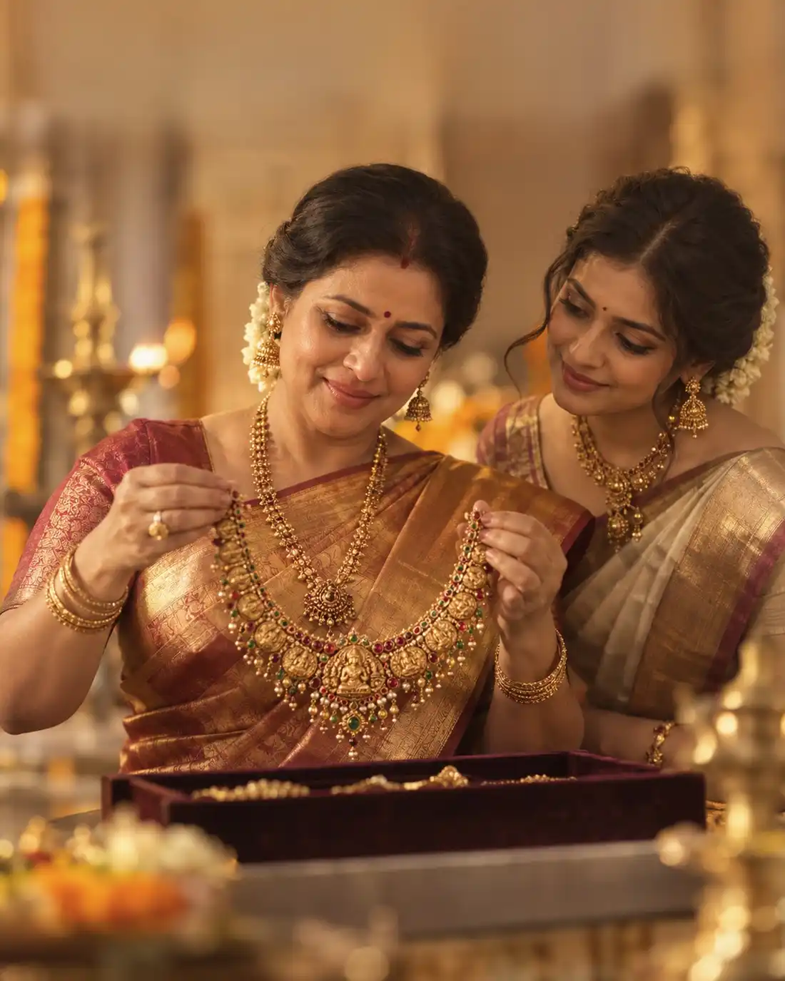 A mother showing her daughter the family’s gold wedding necklace