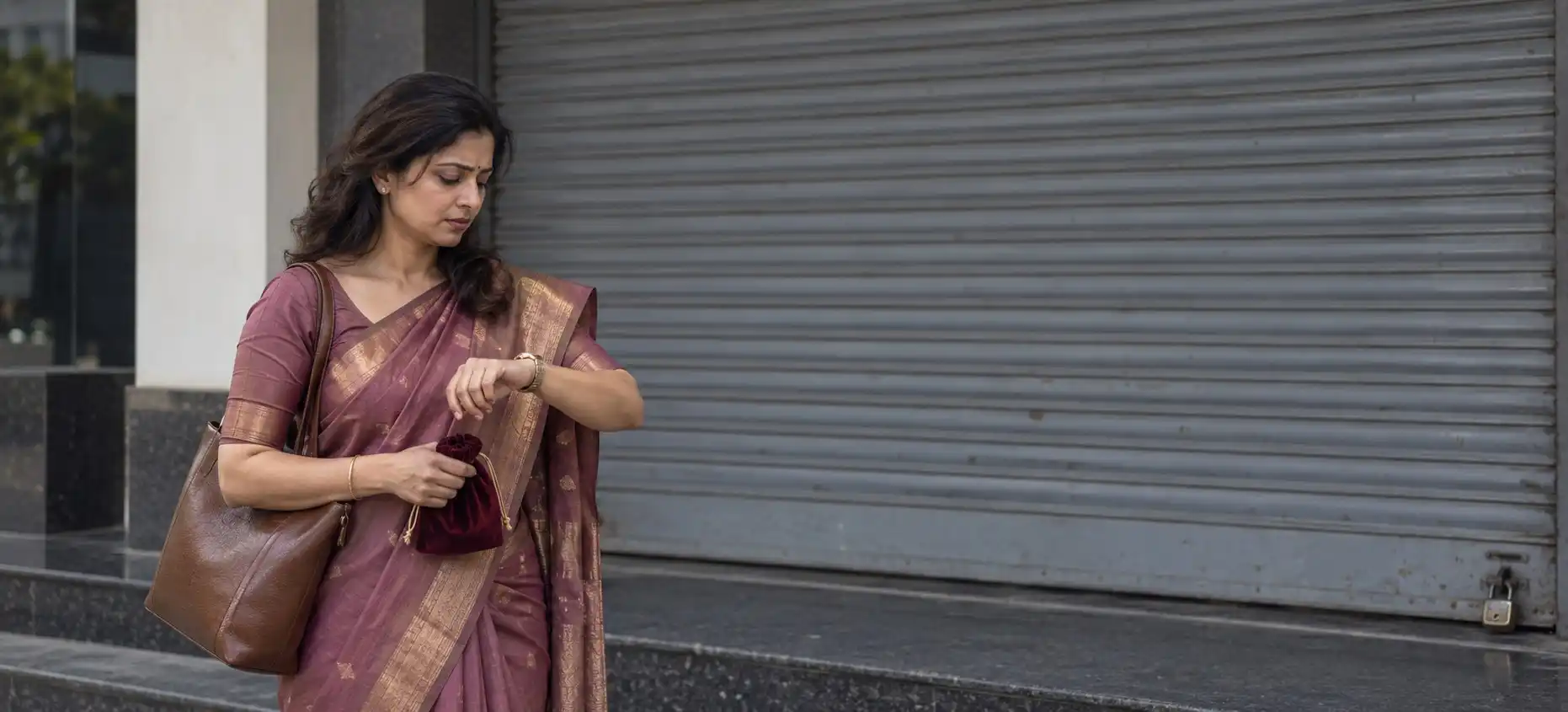 A customer outside her bank’s closed shutter on a Sunday morning